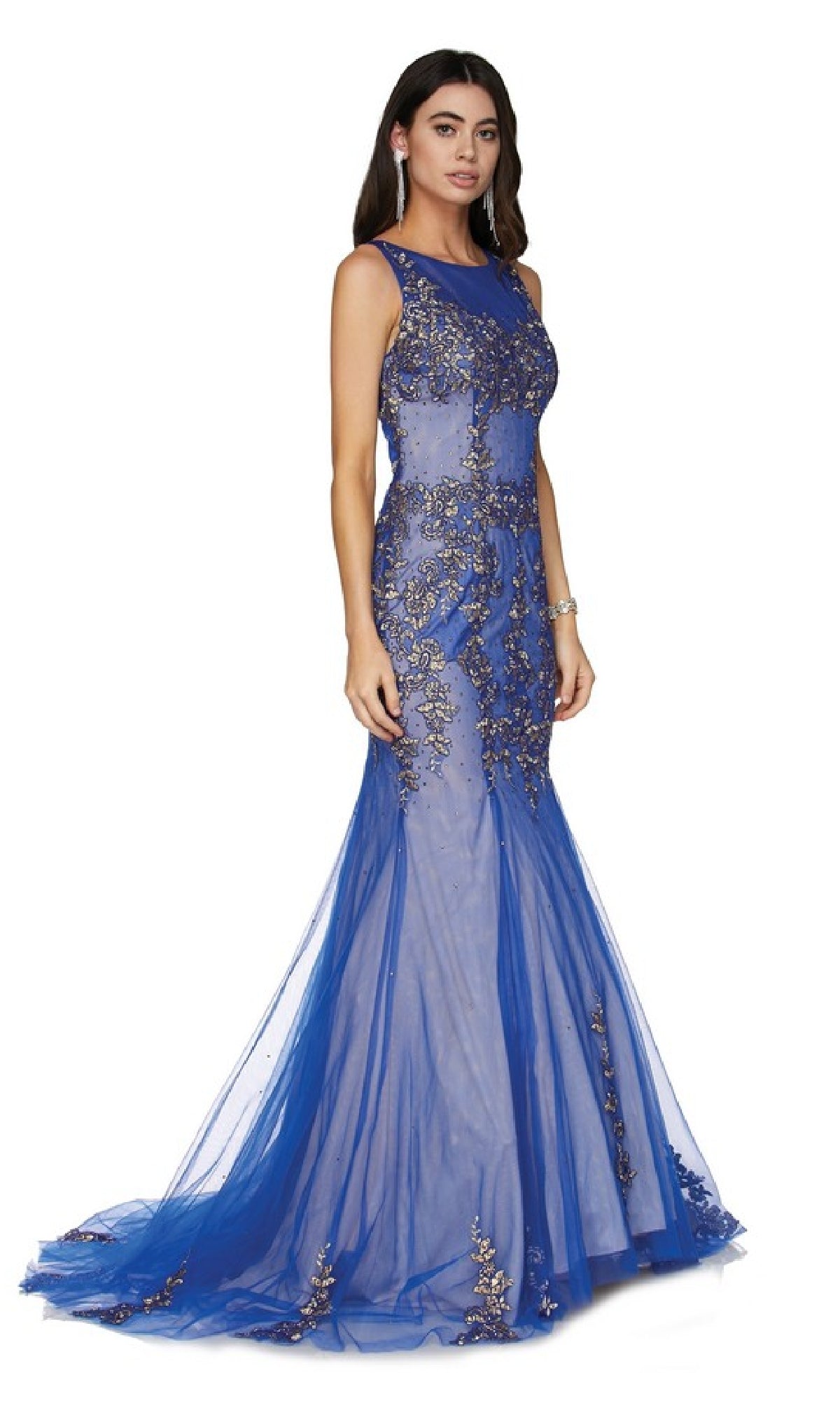A woman models the Long Prom Dress: Juliet 656—a sleeveless, floor-length blue gown with sheer fabric and intricate gold embellishments—against a white background. This sparkly dress is perfect for making an entrance at prom.